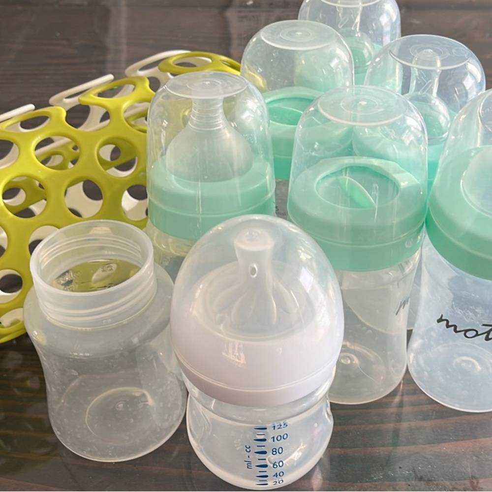 Baby bottles and green dishwashing small parts cage